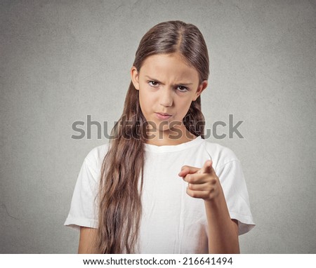 Blame, accusation. Portrait angry child bossy teenager girl pointing finger at someone displeased isolated grey wall background. Negative human face expressions, emotions, feelings, body language