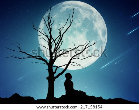 Silhouette of a man sitting under the tree meditating isolated on beautiful background of moon, earth, night skyline, falling stars. Body vitality, human spirit wellbeing concept. Alternative medicine