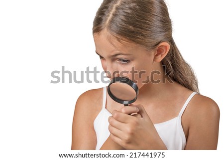 Curious. Child looking through a magnifying glass, isolated on white background. Human face expressions