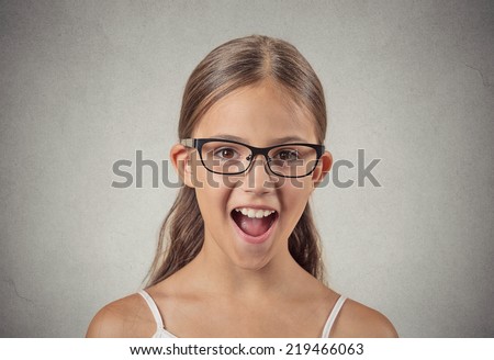 Surprise. Closeup portrait teenager girl with glasses shocked wide open mouth eyes jaw drop blown away isolated grey wall background. Human emotion facial expression feeling body language reaction