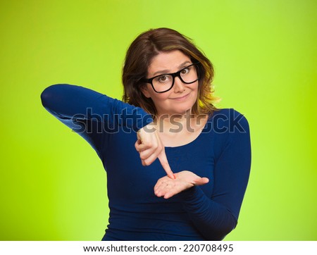 middle aged woman asking to pay money back, finger on palm gesture, isolated green background. Human face expression, emotions, feeling, body language non verbal communication. Financial debt concept