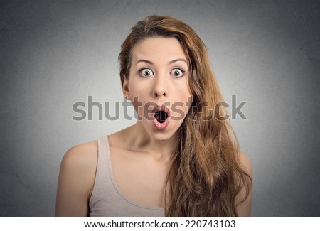 Surprise astonished woman. Closeup portrait woman looking surprised in full disbelief wide open mouth isolated grey wall background. Positive human emotion facial expression body language. Funny girl