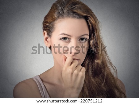 portrait of worried woman thinking looking at you camera isolated grey wall background. human face expressions, emotions, feelings