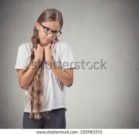 Closeup portrait little, cute, shy teenager girl hands on chest isolated grey wall background. Human face expression emotion reaction life perception anxiety social situation body language