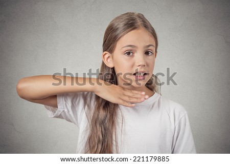 Closeup portrait angry teenager girl gesturing with hand stop talking, cut it out, she will take your head off isolated grey wall background. Negative human emotion facial expression feelings attitude