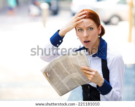 Shocked, astonished businesswoman reading newspaper, bad news outside city street background. Human face expressions, emotions, feelings, body language
