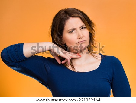Cut it out all nonsense. Portrait angry woman gesturing to stop talking or she will take your head off isolated orange background. Negative emotion face expression bad feeling non verbal communication