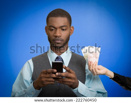 Business man texting, reading news, e-mail working on smartphone, getting paid money, euro cash back, isolated on blue background. Human facial expression emotion, feeling perception. Phone addiction