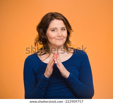 Closeup portrait sneaky, sly, scheming middle aged woman trying to plot plan revenge, prankster isolated orange background. Negative human emotion facial expression feeling body language