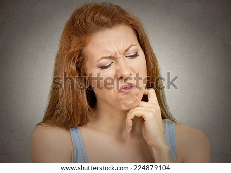Closeup portrait displeased pissed off angry grumpy offended young funny looking woman with bad attitude dissatisfied isolated grey background. Negative human emotion face expression grimace feeling