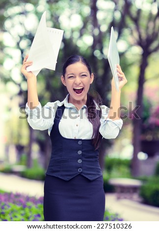 Successful business woman with arms up celebrating. Portrait winning young ecstatic student being winner isolated outside background. Positive human emotion face expression. Life achievement concept