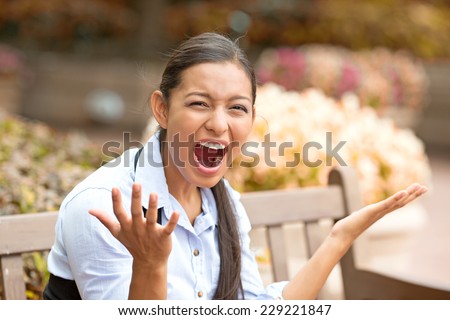stressed frustrated young woman screaming having nervous breakdown isolated outside street park background. Negative human emotion face expression feeling. long working hours concept
