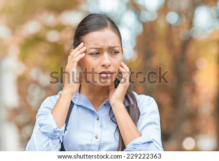 Stress. Closeup portrait unhappy business woman hands on head bothered by mistake having bad headache isolated outside outdoors background with autumn trees. Negative human emotion facial expression