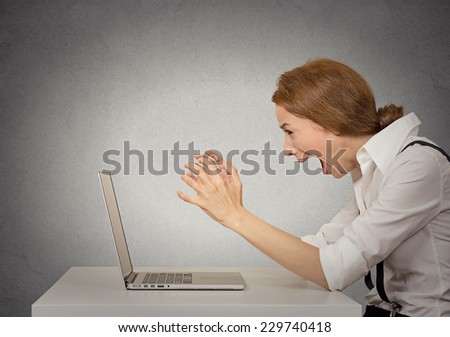 Angry furious businesswoman sitting in front of computer screaming. Negative human emotions, facial expressions, feelings, aggression, anger management issues concept