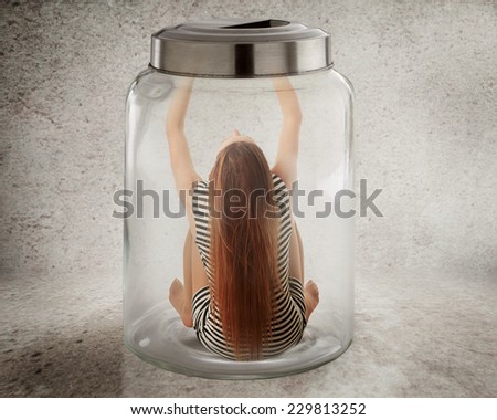 Lack, violation of human rights liberty. Young lonely woman sitting in glass jar isolated grey wall background. Suppression of freedom, restrain, employee working conditions, life limitation concept