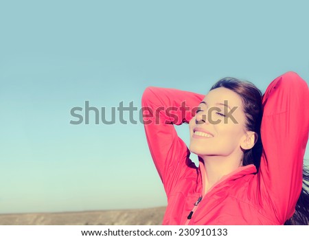 Woman smiling arms raised up to blue sky, celebrating freedom. Positive human emotions, face expression feeling life perception success, peace of mind concept. Free Happy girl on beach enjoying nature