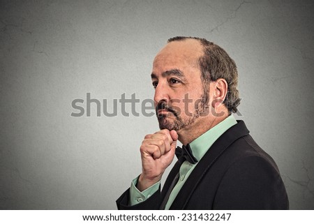 Side profile portrait middle aged thoughtful man with worried face expression looking pensive isolated grey wall background copy space. Human emotion body language perception vision life situation