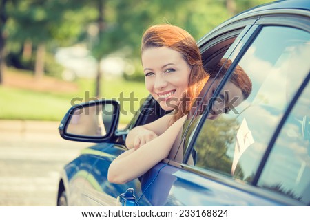 Closeup portrait happy smiling young attractive woman buyer sitting in her new car excited ready for trip isolated outside dealer dealership lot office. Personal transportation auto purchase concept