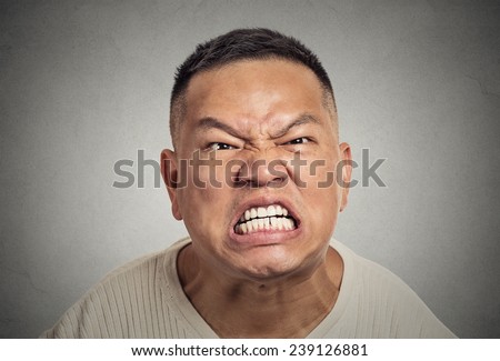 Closeup portrait headshot angry middle aged man with open mouth aggressive screaming isolated grey wall background. Negative human emotion facial expression feeling body language reaction