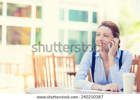 Portrait young happy smiling woman talking on mobile phone outside corporate office building isolated city background college campus. Positive human face expression emotion life success concept