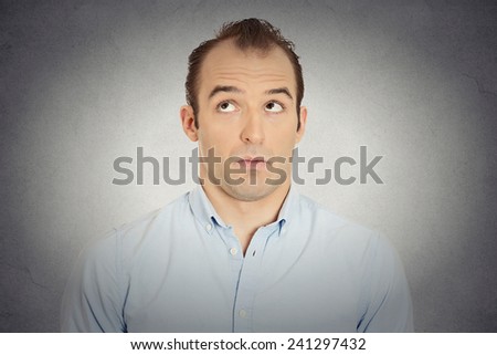 Closeup portrait headshot jealous envious guilty sly businessman employee funny guy sneakily looking aside avoiding eye contact assessing situation isolated grey wall background. Human face expression