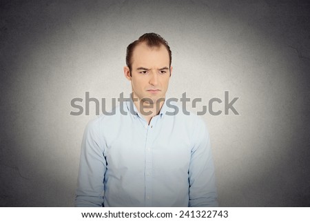Closeup portrait angry sad annoyed, skeptical, grumpy business man employee worker isolated grey wall background. Human emotion face expression, reaction, feelings interpersonal conflict resolution