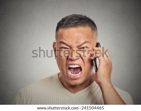 Closeup portrait headshot angry middle aged man, guy mad worker, pissed off employee shouting while on phone isolated grey wall background. Negative human emotion face expression feeling attitude