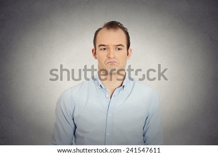 Closeup portrait of angry sad annoyed skeptical, grumpy business man upset employee worker isolated grey wall background. Human emotions face expression reaction interpersonal conflict resolution