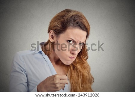 portrait angry woman on grey background. Negative emotion
