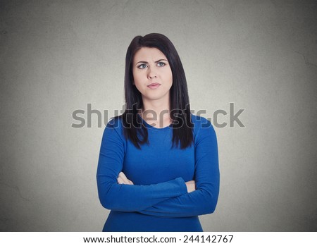 Closeup portrait grumpy annoyed, sad, unhappy, dissatisfied young woman, wife, employee, customer, isolated grey wall background. Human face expressions, emotions, reaction, attitude, perception