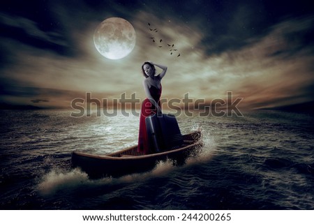 Elegant beautiful stylish woman with suitcase standing on a boat in a middle of the ocean after storm drifting away from her past on moonlight sky clouds background. Conceptual landscape screen saver