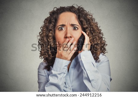 Headshot shocked stunned young woman getting bad news while talking on mobile phone isolated grey wall background. Negative human face expression emotion feelings life perception