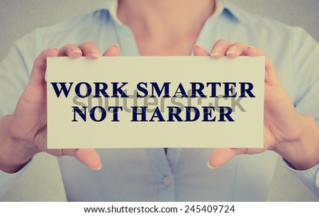 Work Smarter Not Harder Concept. Closeup retro style image business woman hands holding card with motivational message phrase text written on it isolated grey office wall background