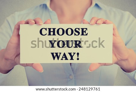 Closeup businesswoman hands holding white card sign with choose your way text message isolated on grey wall office background. Retro instagram style image