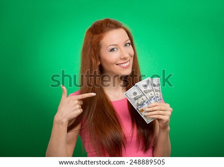 Closeup portrait super happy excited successful young business woman holding money dollar bills in hand isolated on green background. Positive emotion facial expression feeling. Financial reward