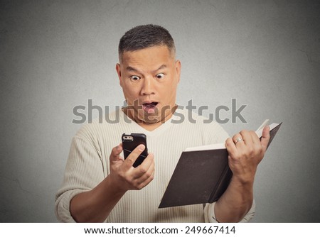 Closeup portrait shocked middle aged man looking at phone seeing bad news or photos. Human emotion, reaction, face expression