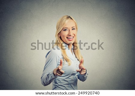 Happy woman with two thumbs up guns hand gesture pointing at you camera