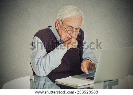 Confused grandfather using a pc