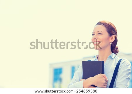 Closeup portrait, young professional, beautiful confident businesswoman in blue shirt smiling isolated outdoor city background. Positive human emotions, facial expressions, life perception