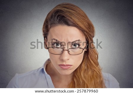 Skepticism. Angry grumpy doubtful woman looking at you camera isolated on grey wall background. Negative human emotion facial expression feeling body language attitude