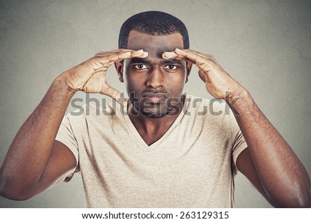 headshot young man looking into future searching for new opportunities isolated on gray wall background