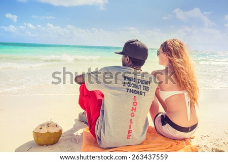 Where there is a coconut tree there is long life. Happy young couple enjoying ocean view in tropical paradise