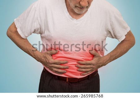 Stomach ache, man placing hands on the abdomen isolated on light blue background