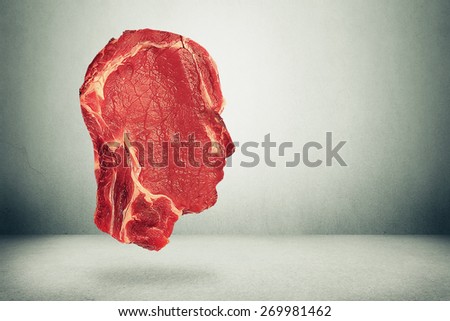 Food balance health related eating choices. Red steak meat shaped as human head. Nutritional decisions and diet concept