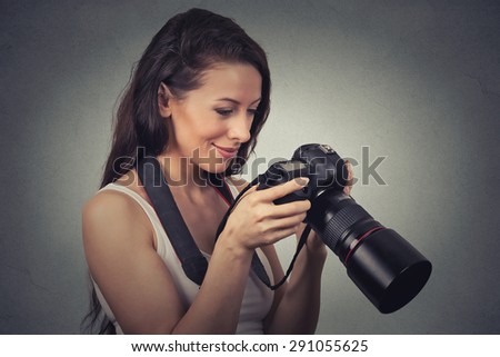 Closeup portrait of a young photographer using a reflex camera