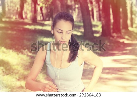 Woman running in summer forest. Female runner training outdoor in profile. Healthy lifestyle image of young woman jogging outside. Fit Caucasian fitness model.