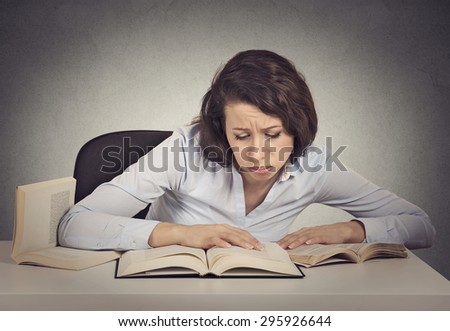 Portrait young woman student with desperate expression looking at her books, too much work to do