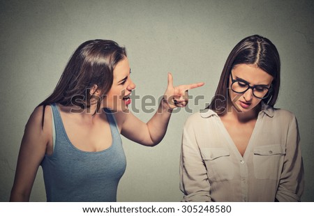 Bullying, friendship and people concept. Girl patronizing screaming pointing finger at shy timid nerdy woman who is looking down