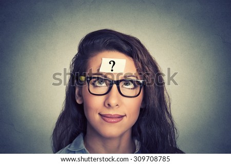thinking woman with question mark on gray wall background