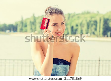 woman shopping on line holding showing credit card